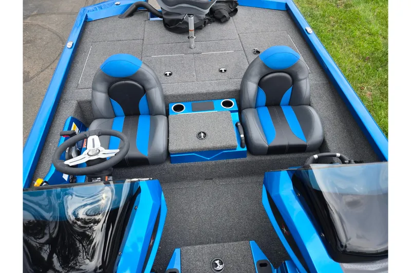 Slide: The Image of 2022 Vexus AVX2080 boat interior with blue and black seats, steering wheel, and console. - 22