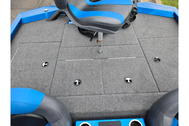 Slide: The Image of 2022 Vexus AVX2080 boat deck with gray carpet and blue-accented seating. - 24