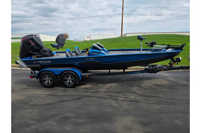 Slide: The Image of 2022 Vexus AVX2080 boat on trailer, blue exterior, parked on pavement. - 4