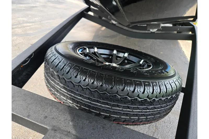 Slide: The Image of 2022 Vexus AVX2080 trailer tire with black alloy wheel on pavement. - 7