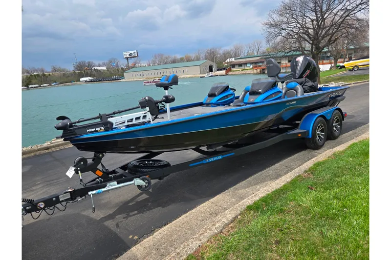 Slide: The Image of 2022 Vexus AVX2080 boat on trailer by a lakeside road. - 9