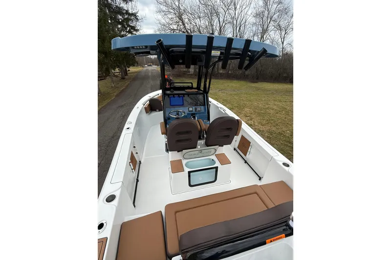 Slide: The Image of 2026 Sea Pro 245FLXR Sandbar boat interior with brown seating and modern dashboard. - 10