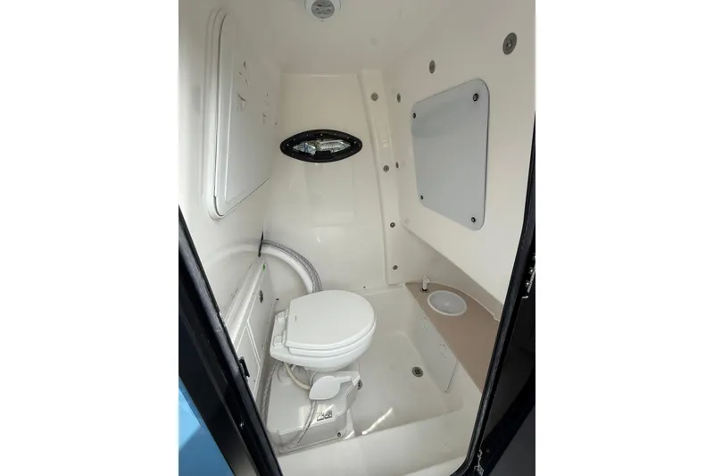 Slide: The Image of Interior of 2026 Sea Pro 245FLXR Sandbar boat bathroom with toilet and sink. - 12