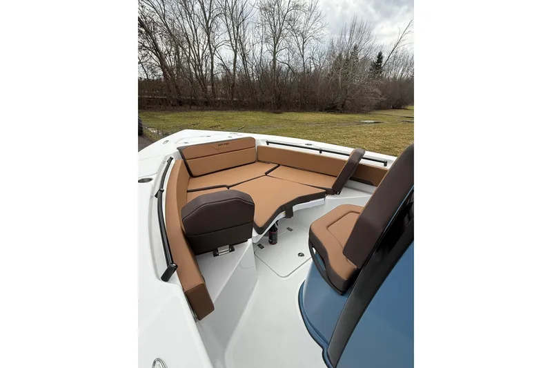 Slide: The Image of 2026 Sea Pro 245FLXR Sandbar boat interior with brown seating and spacious layout. - 6