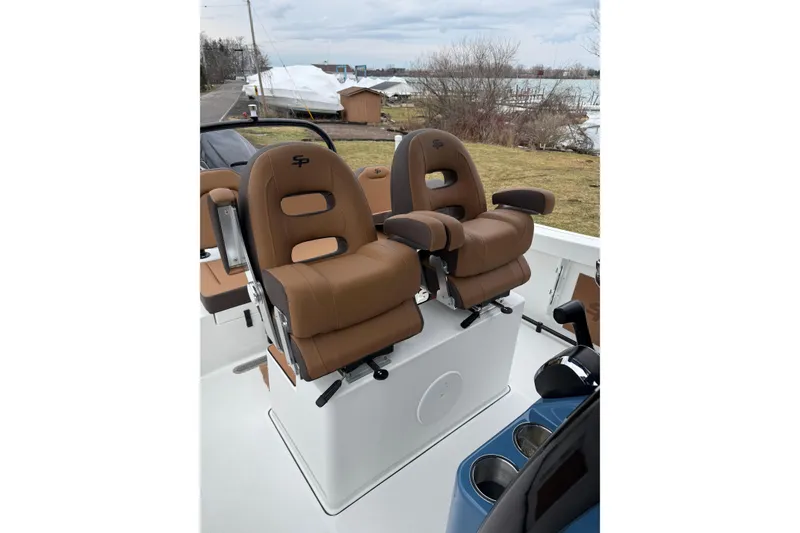 Slide: The Image of 2026 Sea Pro 245FLXR Sandbar boat with brown captain seats and scenic waterfront view. - 8