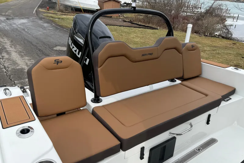 Slide: The Image of 2026 Sea Pro 245FLXR Sandbar boat with tan seating and Suzuki engine. - 9