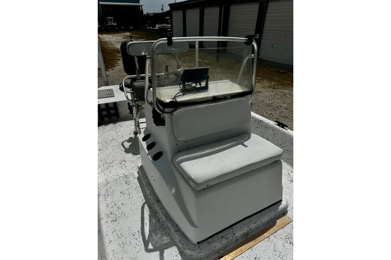 Slide: The Image of 2007 Haynie 23 Bigfoot boat console with seating and steering wheel in storage area. - 11