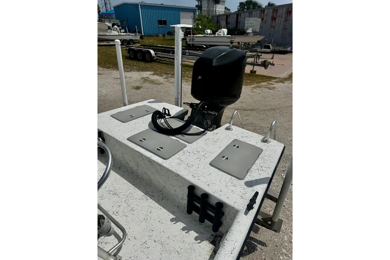 Slide: The Image of 2007 Haynie 23 Bigfoot boat with outboard motor in a yard setting. - 17