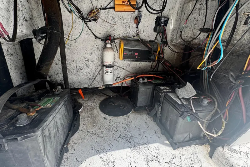 Slide: The Image of Electrical setup inside a 2007 Haynie 23 Bigfoot boat, featuring batteries and wiring. - 25