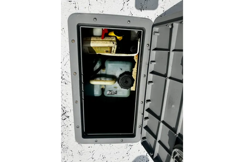 Slide: The Image of Open storage compartment on a 2007 Haynie 23 Bigfoot boat, showing internal components. - 27