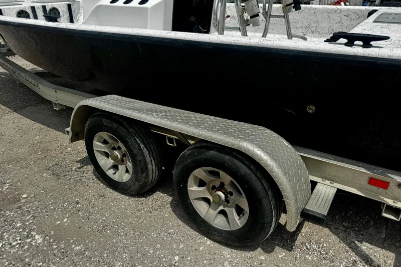 Slide: The Image of Trailer with dual wheels carrying a 2007 Haynie 23 Bigfoot boat. - 29