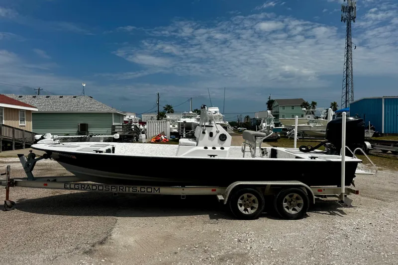 Slide: The Image of 2007 Haynie 23 Bigfoot boat on trailer, parked outdoors under a partly cloudy sky. - 3