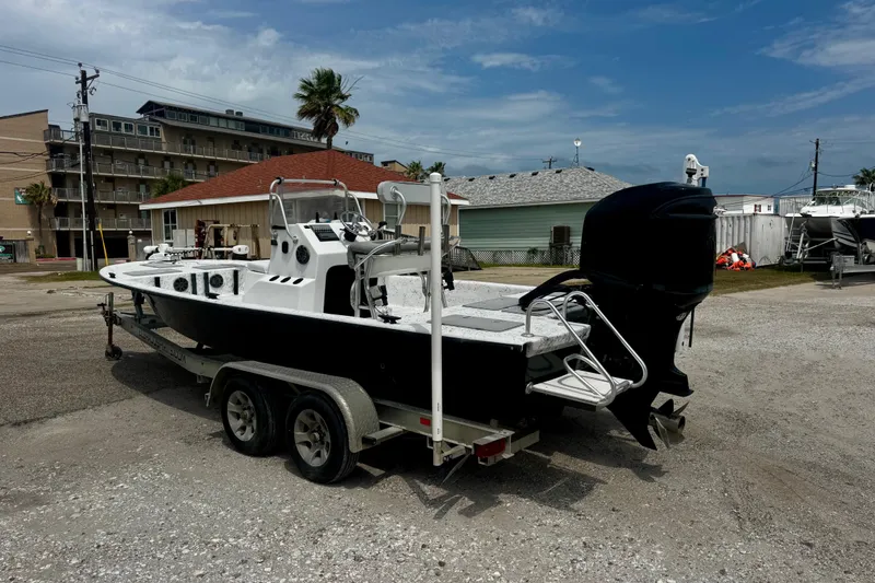 Slide: The Image of 2007 Haynie 23 Bigfoot boat on trailer in coastal setting, ready for adventure. - 6