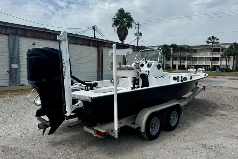 Slide: The Image of 2007 Haynie 23 Bigfoot boat on trailer, parked outdoors near buildings. - 7