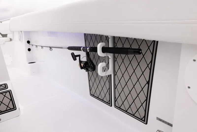 Slide: The Image of 2023 Wellcraft 222 Fisherman boat interior with fishing rod holder and storage compartments. - 11