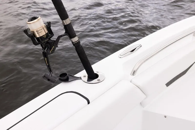 Slide: The Image of Fishing rod holder on 2023 Wellcraft 222 Fisherman boat, near water. - 12