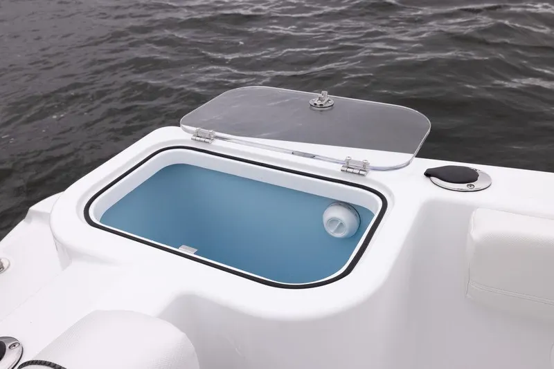 Slide: The Image of 2023 Wellcraft 222 Fisherman livewell with open lid on calm water. - 15