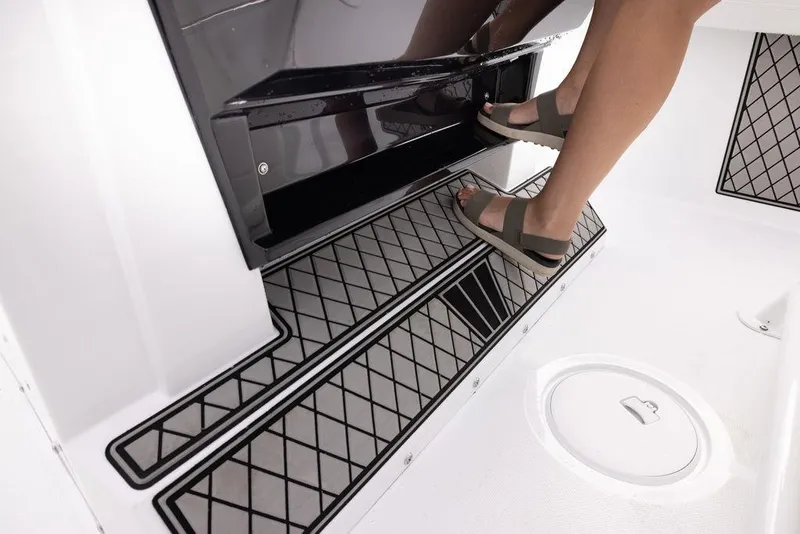 Slide: The Image of Person stepping on Wellcraft 222 Fisherman 2023 boat's textured deck. - 18