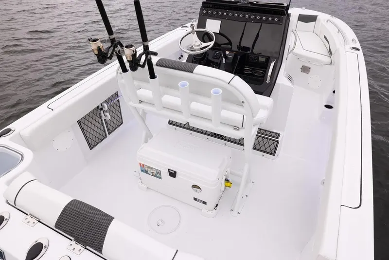 Slide: The Image of 2023 Wellcraft 222 Fisherman boat interior with fishing rod holders and steering console. - 3