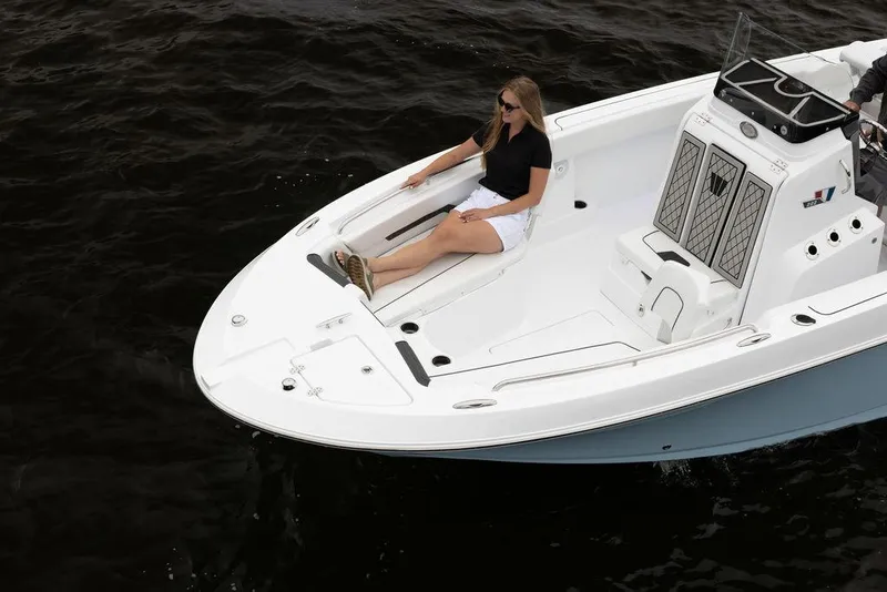 Slide: The Image of 2023 Wellcraft 222 Fisherman boat with a person relaxing on deck. - 5