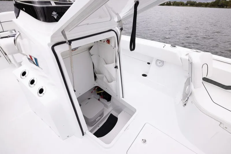 Slide: The Image of 2023 Wellcraft 222 Fisherman boat interior with open storage compartment. - 9