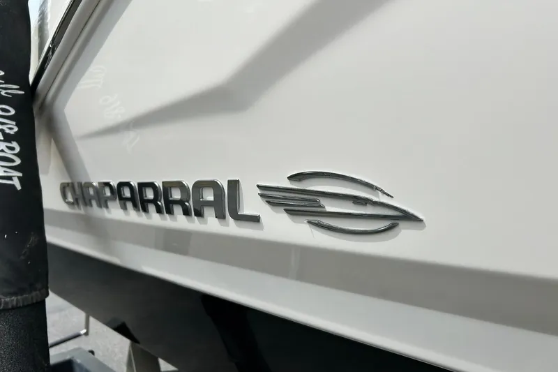 Slide: The Image of 2016 Chaparral 21 H2O Sport boat emblem on white hull. - 10