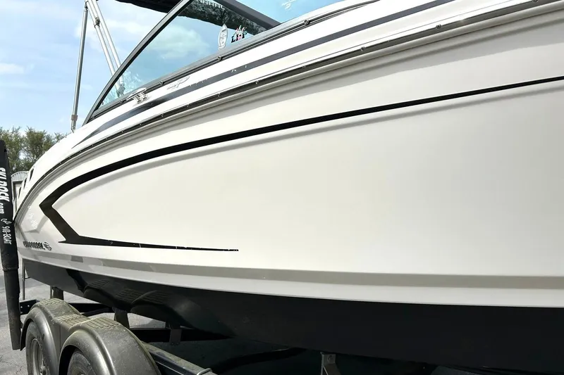 Slide: The Image of 2016 Chaparral 21 H2O Sport boat on trailer, sleek white design. - 11