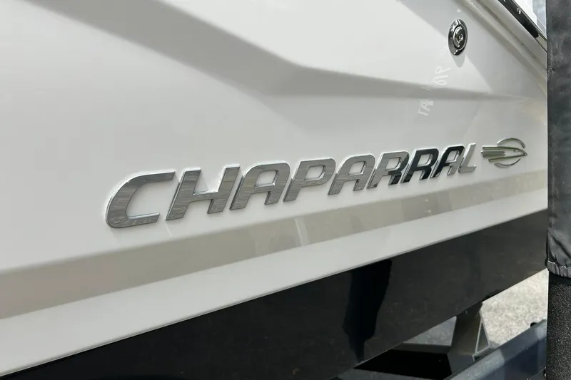 Slide: The Image of 2016 Chaparral 21 H2O Sport boat logo on white hull. - 19