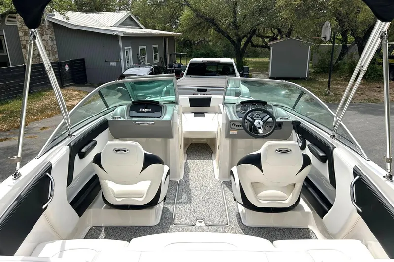 Slide: The Image of 2016 Chaparral 21 H2O Sport boat interior with dual seating and steering console. - 2