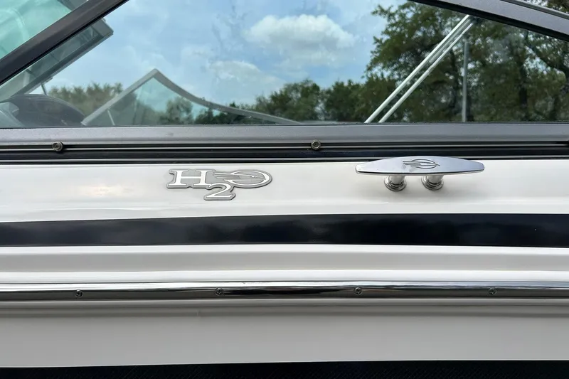 Slide: The Image of 2016 Chaparral 21 H2O Sport boat side view with logo and cleat. - 20