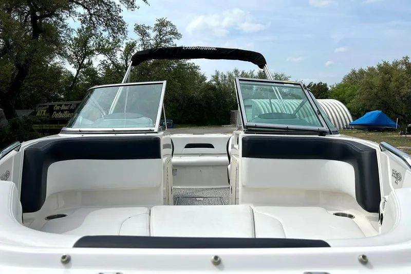 Slide: The Image of 2016 Chaparral 21 H2O Sport boat interior with open windshield and seating area. - 22
