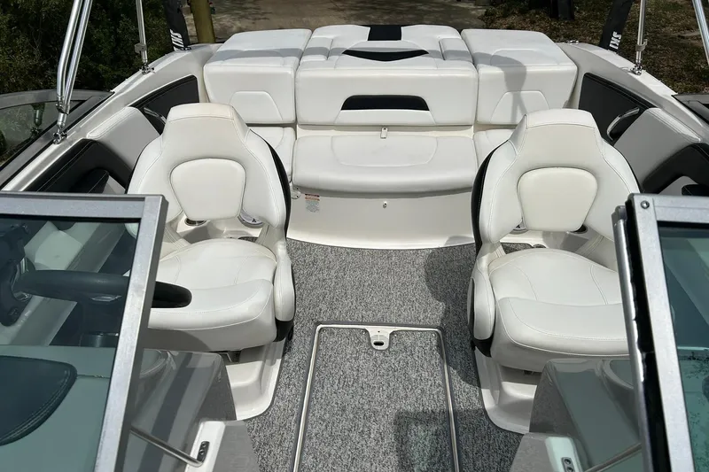 Slide: The Image of Interior of 2016 Chaparral 21 H2O Sport boat with white seating and carpeted floor. - 28