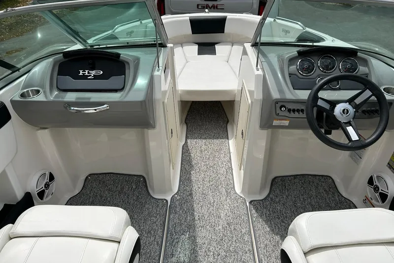 Slide: The Image of 2016 Chaparral 21 H2O Sport boat interior with steering wheel and dashboard. - 29