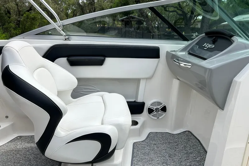 Slide: The Image of Interior of 2016 Chaparral 21 H2O Sport boat with white and black seating. - 30