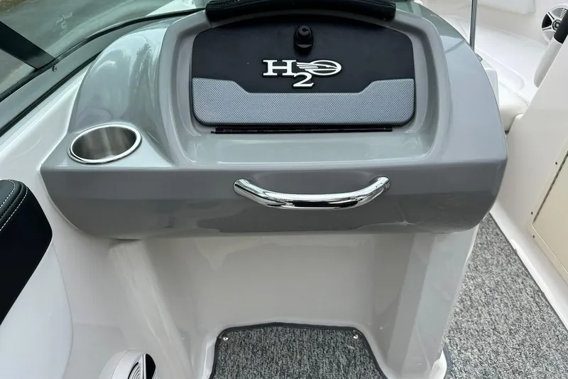 Slide: The Image of 2016 Chaparral 21 H2O Sport dashboard with cup holder and H2O logo. - 31