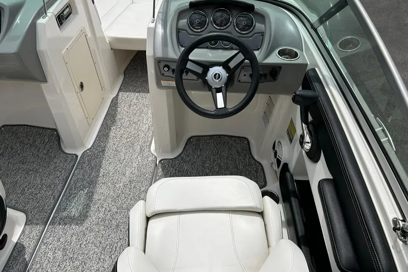 Slide: The Image of Interior view of 2016 Chaparral 21 H2O Sport boat cockpit with steering wheel and seating. - 33