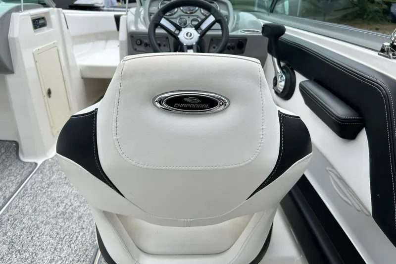 Slide: The Image of 2016 Chaparral 21 H2O Sport boat interior with steering wheel and branded seat. - 34