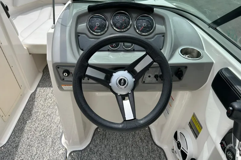 Slide: The Image of 2016 Chaparral 21 H2O Sport boat dashboard with steering wheel and gauges. - 36