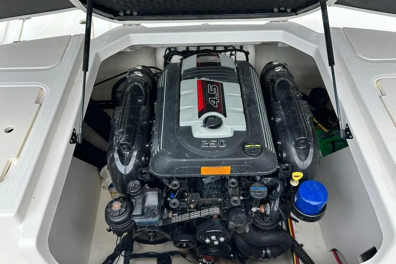 Slide: The Image of Engine compartment of a 2016 Chaparral 21 H2O Sport boat, featuring a 4.5L engine. - 38