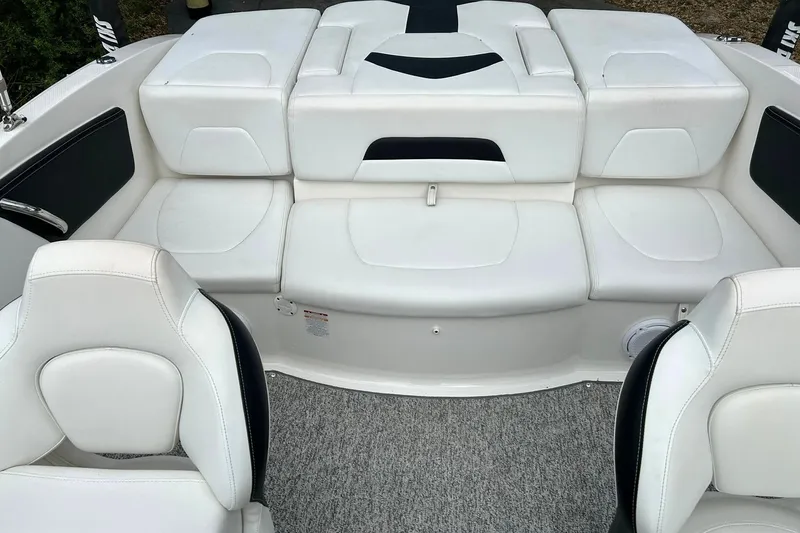 Slide: The Image of 2016 Chaparral 21 H2O Sport boat interior with white cushioned seating and carpeted floor. - 4