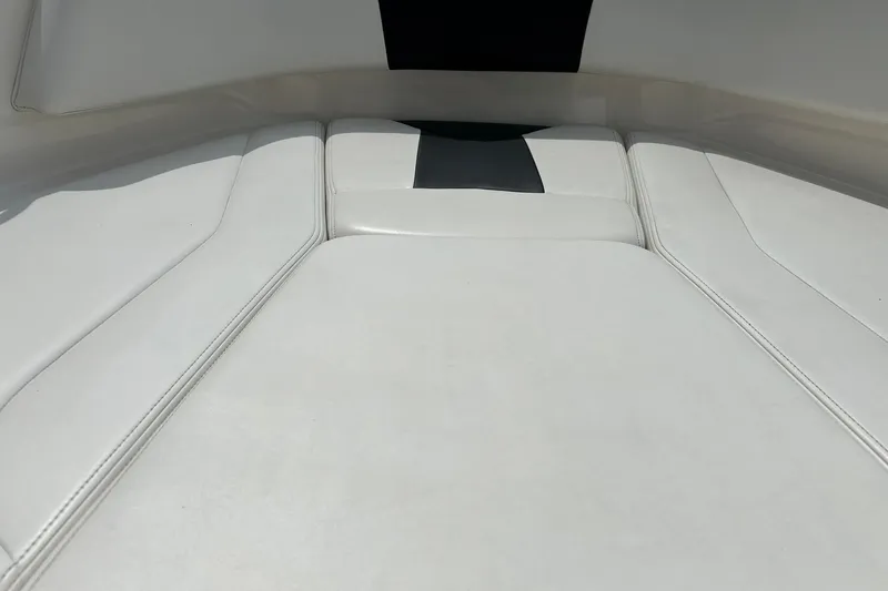 Slide: The Image of 2016 Chaparral 21 H2O Sport boat interior with white cushioned seating. - 42