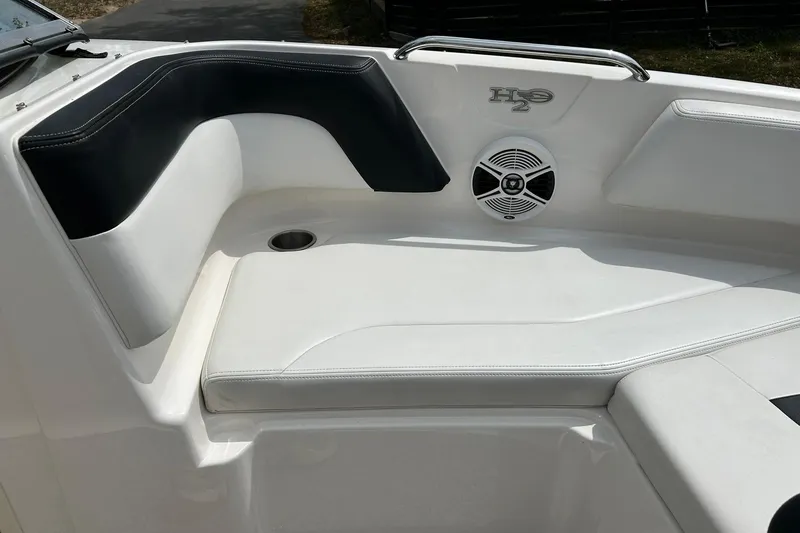 Slide: The Image of 2016 Chaparral 21 H2O Sport boat interior with cushioned seating and speaker. - 46