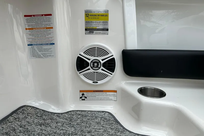 Slide: The Image of Interior of 2016 Chaparral 21 H2O Sport boat with speaker and safety labels. - 49