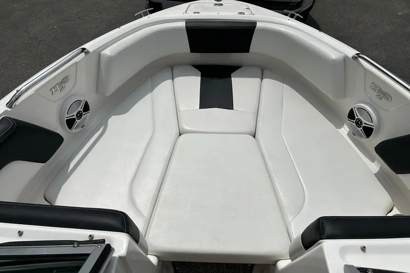 Slide: The Image of 2016 Chaparral 21 H2O Sport boat interior with white seating and built-in speakers. - 5