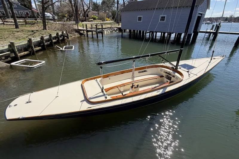 Slide: The Image of 2014 C.W. Hood 32 Daysailer docked in serene waters, reflecting sunlight. - 13