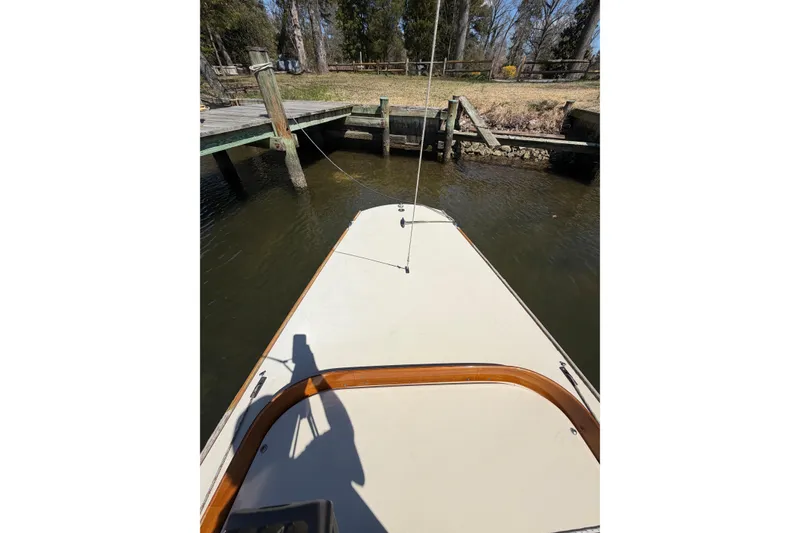 Slide: The Image of Bow view of 2014 C.W. Hood 32 Daysailer docked by wooden pier. - 15