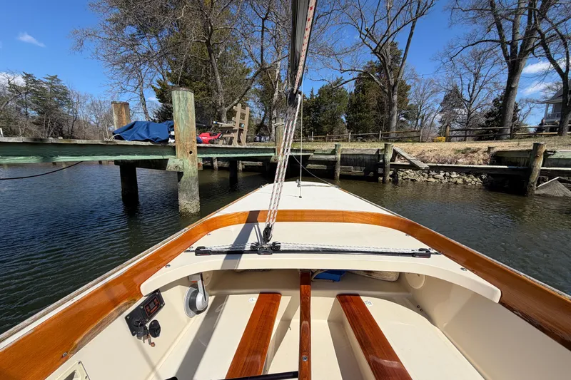 Slide: The Image of C.W. Hood 32 Daysailer, 2014 model, docked by a wooden pier on a sunny day. - 7