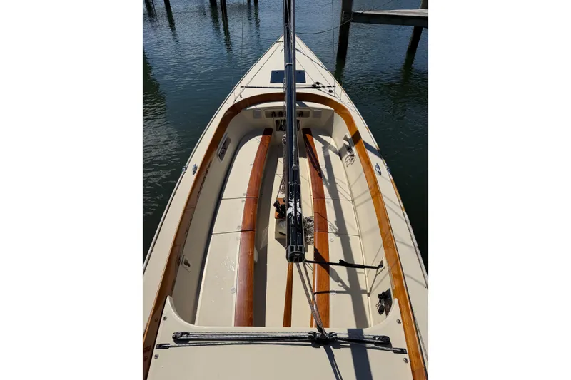 Slide: The Image of 2014 C.W. Hood 32 Daysailer with wooden accents docked on calm water. - 8