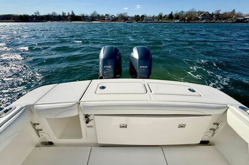 Slide: The Image of 2022 Regulator 23 boat with dual 150 horsepower engines on a scenic lake. - 15