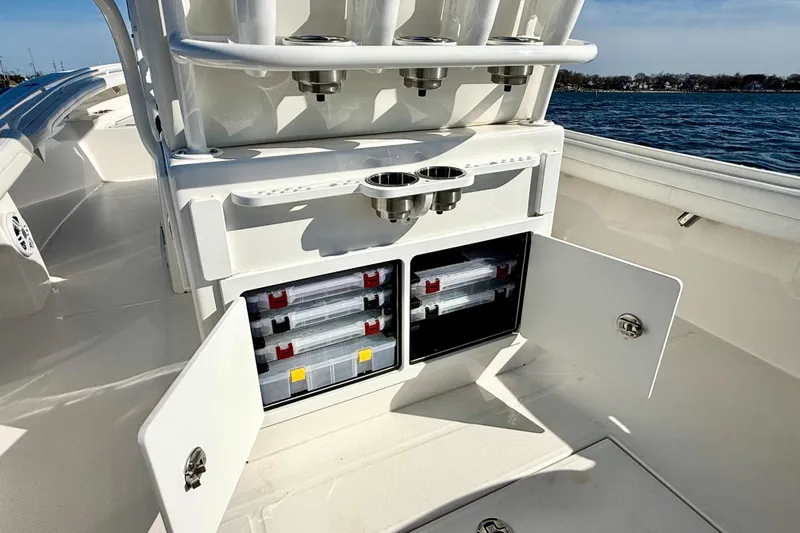 Slide: The Image of 2022 Regulator 23 boat with open storage compartments and cup holders on deck. - 16